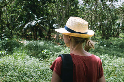 Rear view of woman wearing hat on field