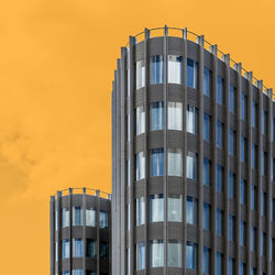 Low angle view of modern building against sky during sunset