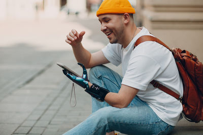 Side view of man using mobile phone