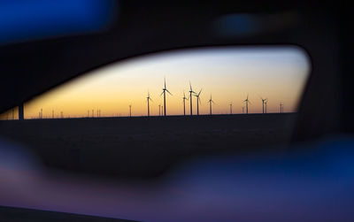 View of colorado wind farm from an automobile side mirror