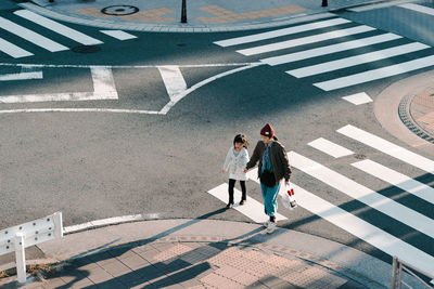 High angle view of people walking on road