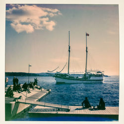 Sailboats on sea against sky