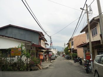 Street amidst buildings against sky