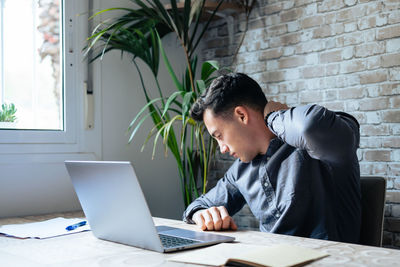 Businesswoman using laptop at office