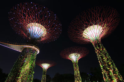 Low angle view of illuminated ferris wheel at night