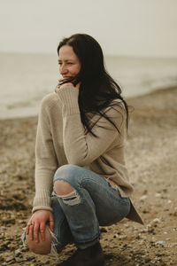 Young woman sitting at beach