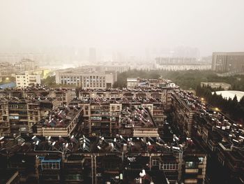 High angle view of buildings in city against sky