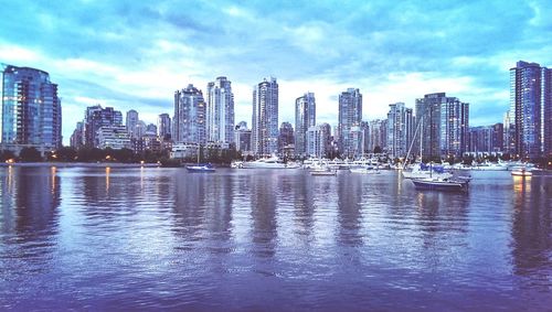 Boats in river with buildings in background