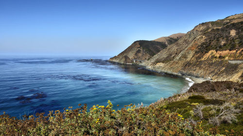 Scenic view of sea against clear blue sky