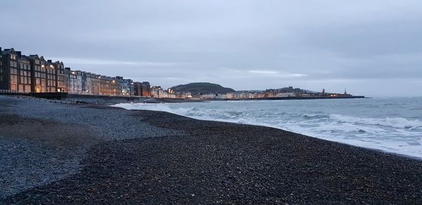 View of sea against buildings in city