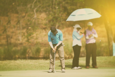 Man playing golf on field