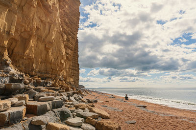 Rocks on beach against sky