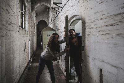 Full length of woman standing against building
