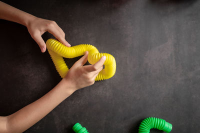 Anti stress sensory pop tube toys in a children's hands. a little kids plays with a poptube toy