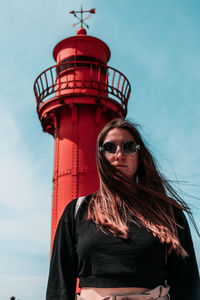 Portrait of woman wearing sunglasses against sky