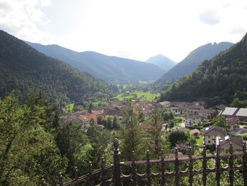 Scenic view of trees and buildings against sky