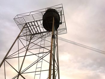 Low angle view of silhouette tower against sky