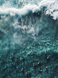 High angle view of people swimming in sea