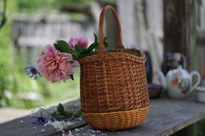 Close-up of flowering plant in basket on table