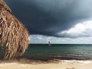 Scenic view of sea against storm clouds