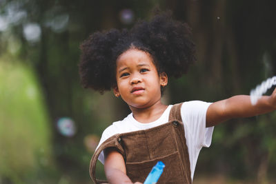 Portrait of happy girl holding outdoors