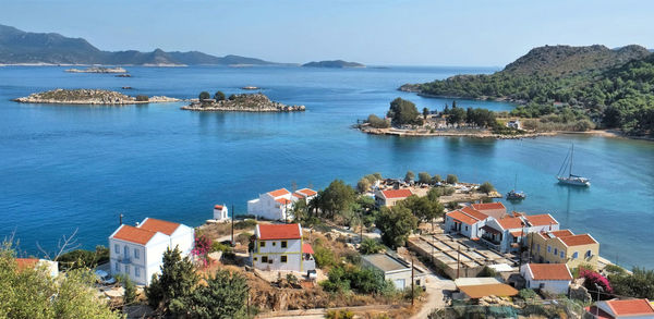 High angle view of sea and houses against sky