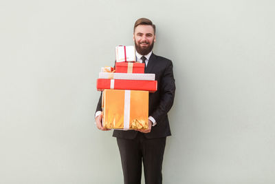 Portrait of smiling young man against white background