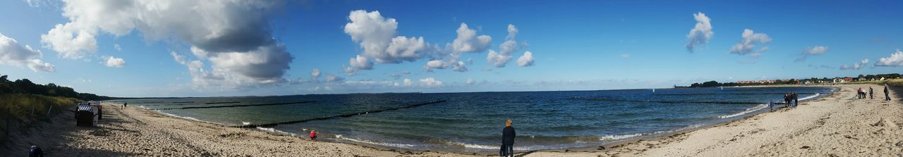 Scenic view of beach against blue sky