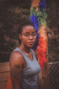 Portrait of woman standing against multi colored wall