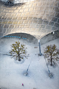 High angle view of snow covered footpath by buildings in city