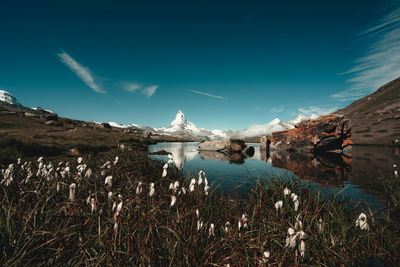 Panoramic view of lake and mountains against blue sky
