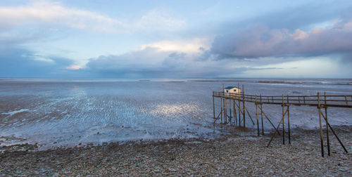 Fisheries on the edge of the atlantic ocean near la rochelle at dawn at low tide