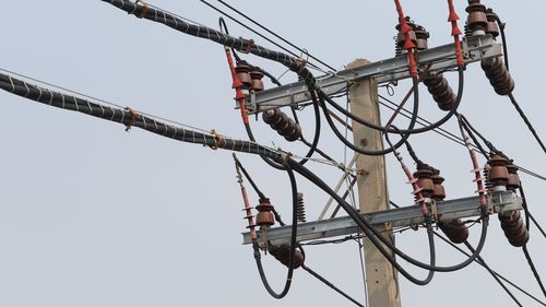 Low angle view of cables against clear sky