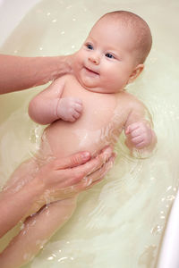 High angle view of woman washing hands in water