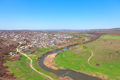 Village situated at the river coast . rustic springtime landscape