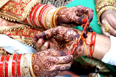 Low section of woman with tattoo on hands