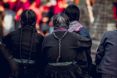 Rear view of females with braided hair