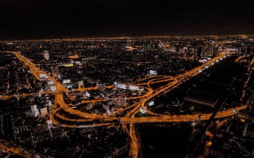 Aerial view of illuminated buildings in city at night