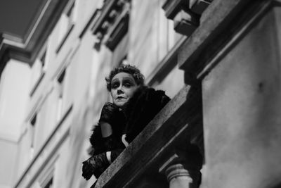 Low angle view of woman in building balcony