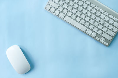 High angle view of laptop on table against blue background
