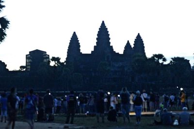 Group of people in front of building at night