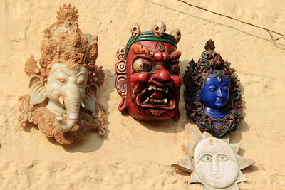 Close-up of buddha statue against wall