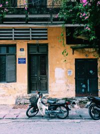 Bicycle parked against building in city
