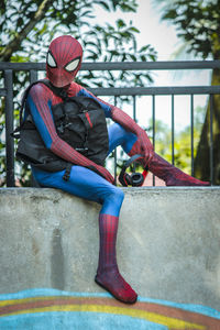 Midsection of man sitting outdoors