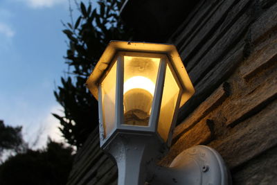 Low angle view of illuminated lamp against sky