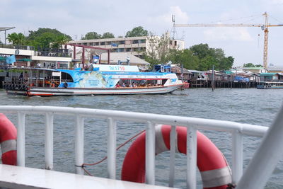 Boats in river with buildings in background