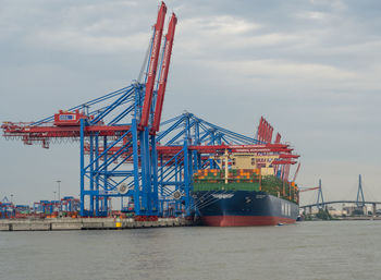 Commercial dock by pier against sky