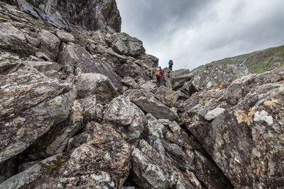 People hiking on scree at jotunheimen national park