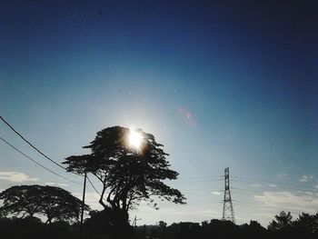 Low angle view of power lines against sky