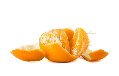 Close-up of orange fruit against white background